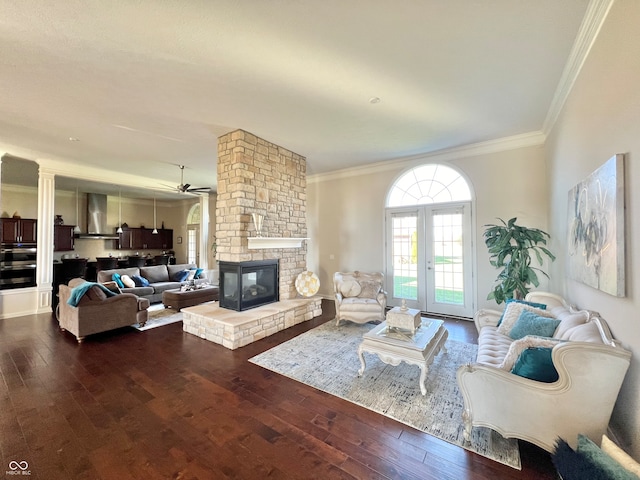 living room featuring hardwood / wood-style floors, a fireplace, and crown molding