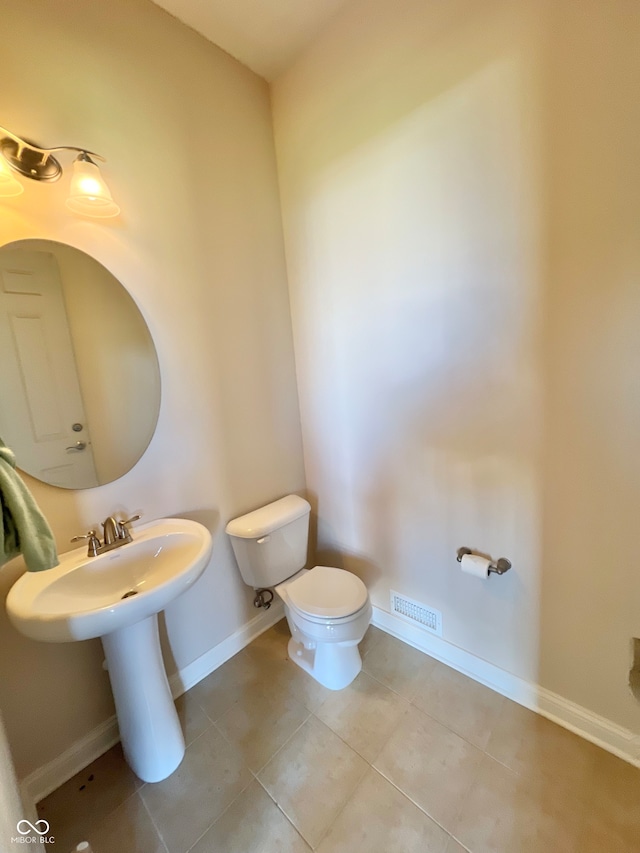 bathroom featuring tile patterned floors and toilet