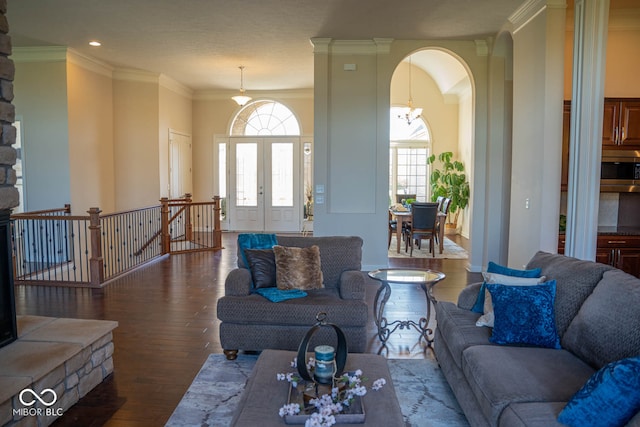 living room featuring ornamental molding, hardwood / wood-style floors, a healthy amount of sunlight, and french doors