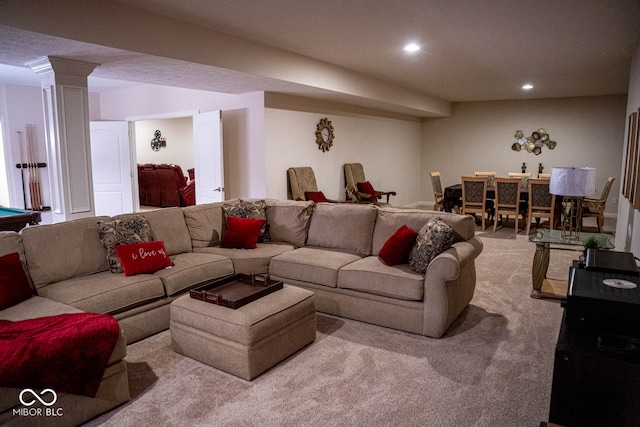 living room featuring ornate columns and light carpet