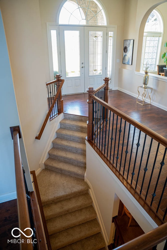 staircase featuring french doors and hardwood / wood-style flooring