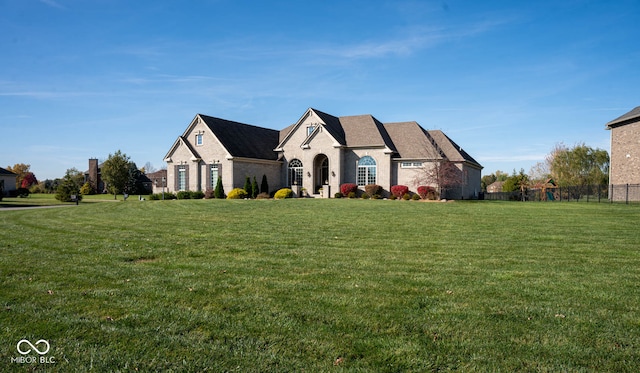 french country style house featuring a front lawn