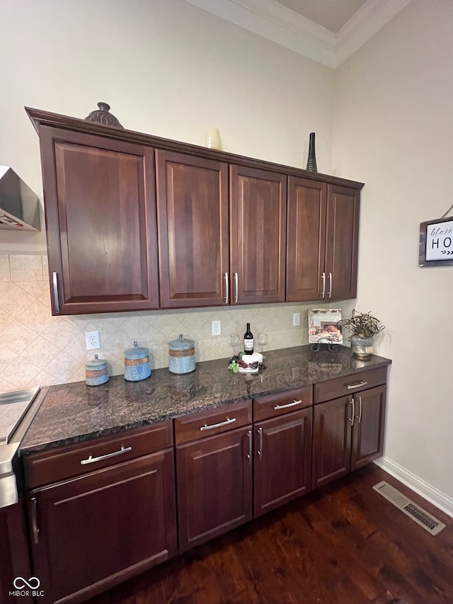 kitchen featuring range with electric cooktop, dark wood-type flooring, ornamental molding, backsplash, and dark stone countertops