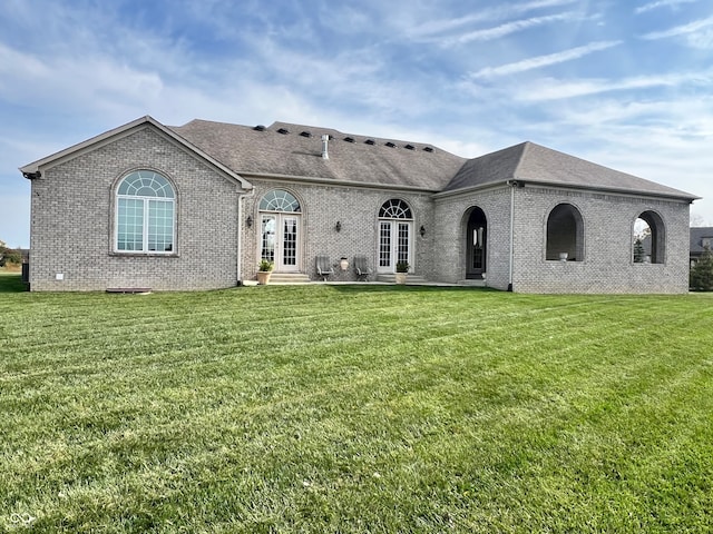 view of front of home with a front yard and french doors