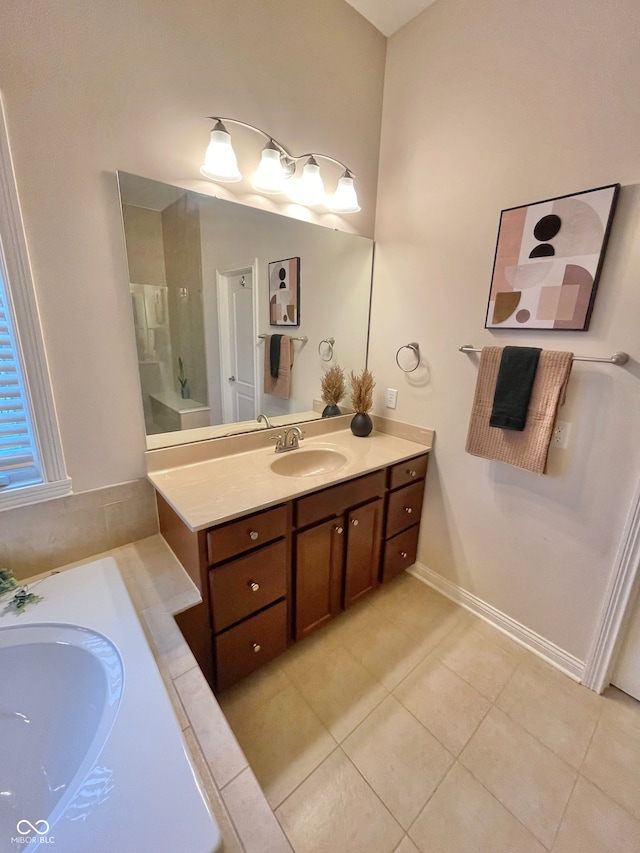 bathroom with a bath, tile patterned floors, and vanity