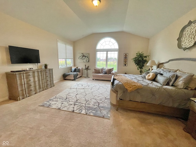 carpeted bedroom with lofted ceiling