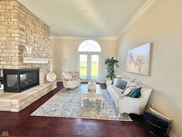 living room featuring french doors, wood-type flooring, ornamental molding, and a fireplace