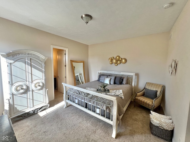 carpeted bedroom featuring a textured ceiling