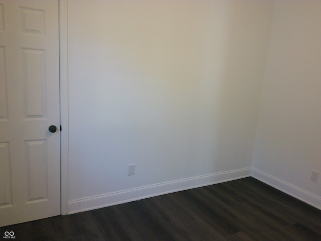 unfurnished room with dark hardwood / wood-style floors