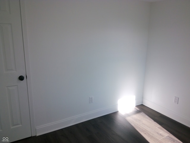 empty room with dark wood-type flooring