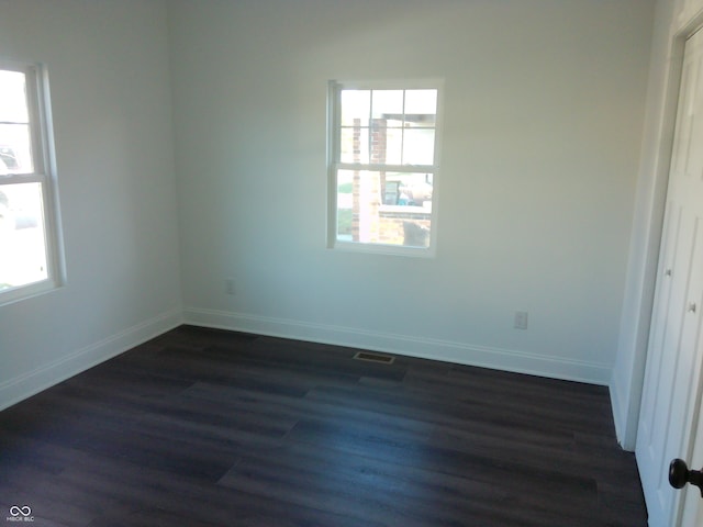 empty room featuring dark hardwood / wood-style flooring