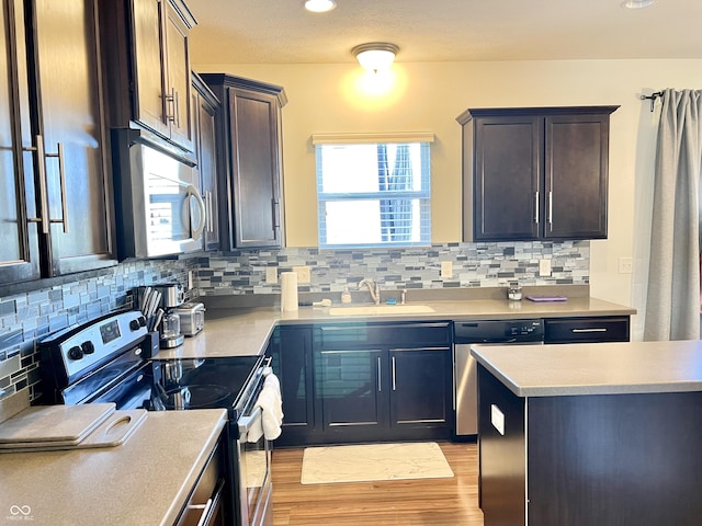 5778 W Commonview Dr, Mccordsville, IN 46055 - kitchen with stainless steel appliances, a sink, light wood-type flooring, light countertops, and backsplash