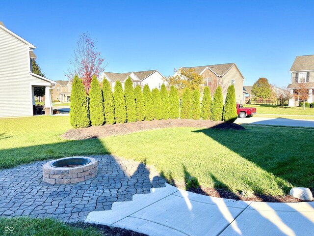 5778 W Commonview Dr, Mccordsville, IN 46055 - view of green lawn featuring a fire pit, a residential view, and a patio area