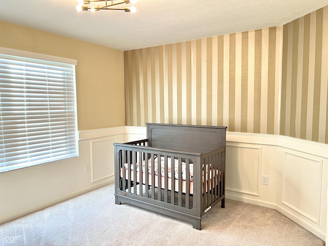 5778 W Commonview Dr, Mccordsville, IN 46055 - carpeted bedroom with a wainscoted wall, multiple windows, a textured ceiling, a nursery area, and a decorative wall