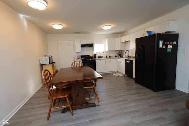 dining space featuring light hardwood / wood-style floors and sink