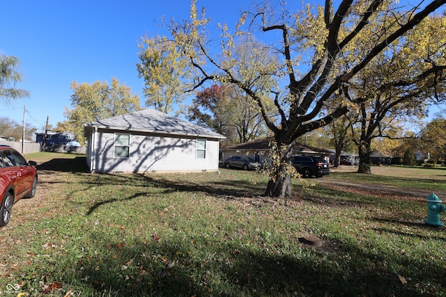 view of property exterior with a yard