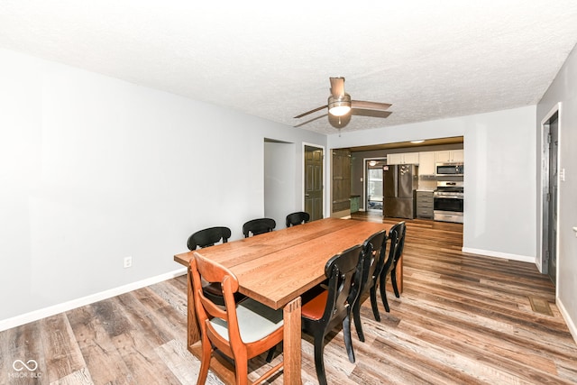 dining space featuring ceiling fan, a textured ceiling, and hardwood / wood-style flooring