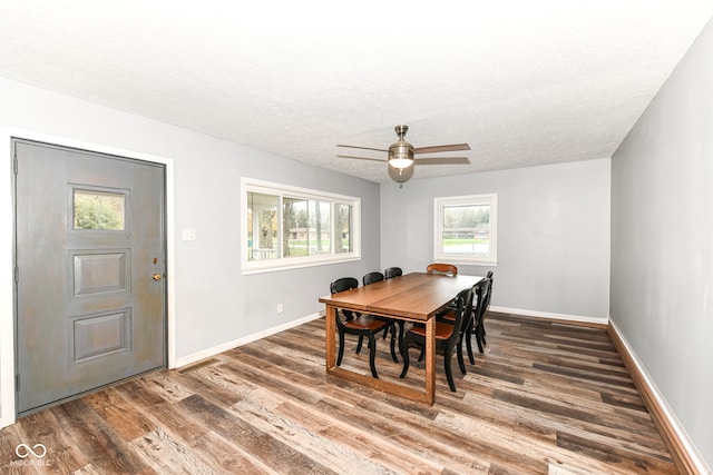 dining room with a textured ceiling, ceiling fan, and dark hardwood / wood-style floors