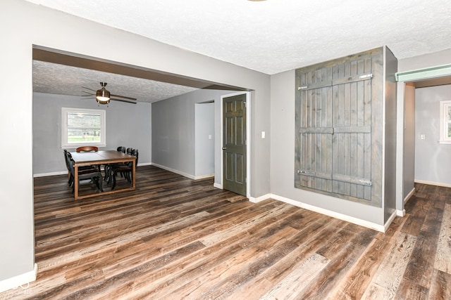 interior space with dark hardwood / wood-style floors, ceiling fan, and a textured ceiling