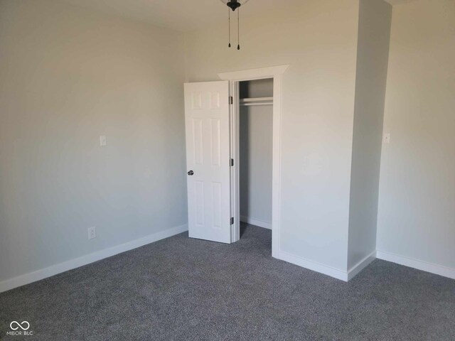 325 E Church St, Paragon, IN 46166 - unfurnished bedroom featuring dark colored carpet, baseboards, and a closet