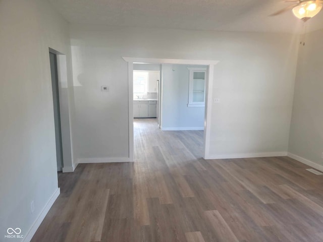 325 E Church St, Paragon, IN 46166 - spare room with wood finished floors, a ceiling fan, and baseboards