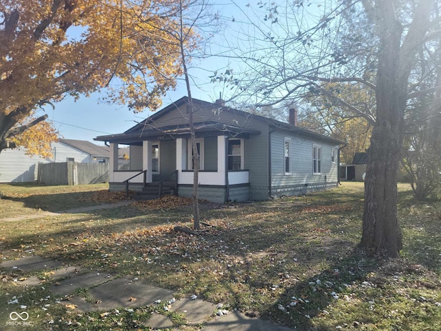 325 E Church St, Paragon, IN 46166 - view of front of house featuring covered porch, a chimney, and fence