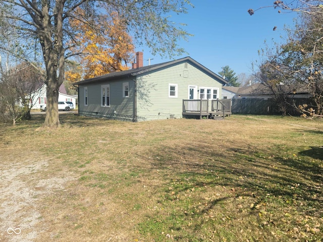 325 E Church St, Paragon, IN 46166 - view of home's exterior with a deck, a chimney, and a lawn