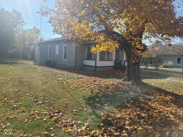 325 E Church St, Paragon, IN 46166 - view of side of home featuring a yard and central AC unit