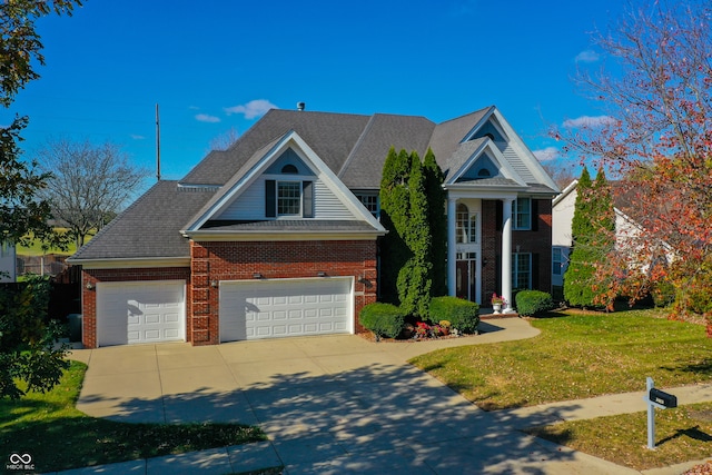 view of front of home with a front yard and a garage