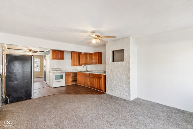 kitchen with light colored carpet, sink, white range with electric cooktop, and black fridge