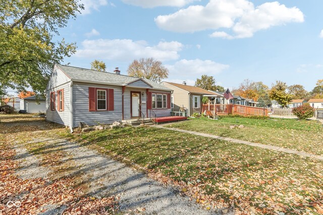 ranch-style home featuring a front yard and a deck