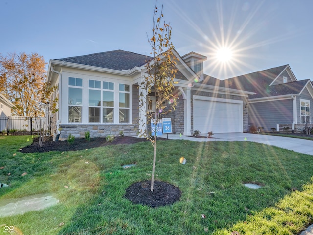 single story home featuring a front yard, fence, a garage, stone siding, and driveway