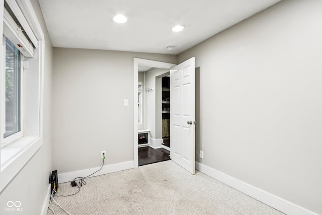 interior space with vaulted ceiling and carpet floors