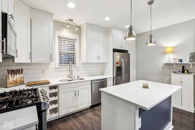 2028 Hoyt Ave, Indianapolis, IN 46203 - kitchen with stainless steel appliances, a sink, dark wood-style flooring, backsplash, and recessed lighting