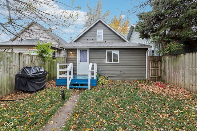 rear view of property with a yard and a deck