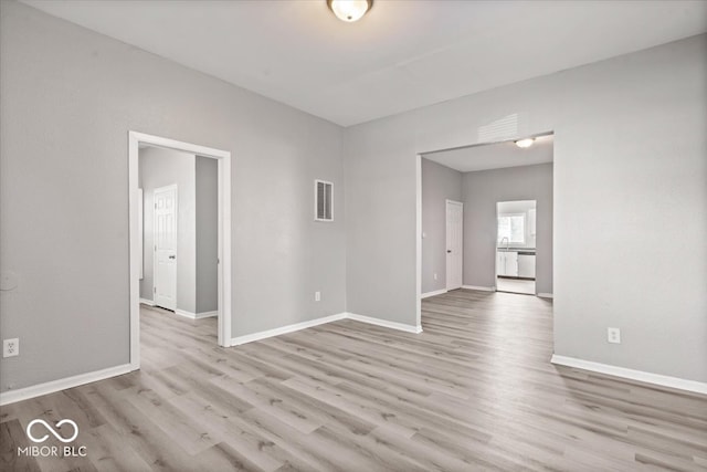 spare room with light hardwood / wood-style flooring