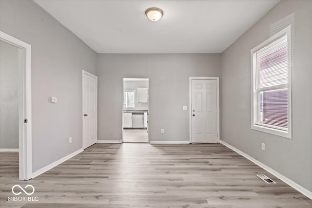 empty room with light hardwood / wood-style floors