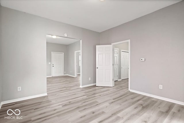 unfurnished room with light wood-type flooring