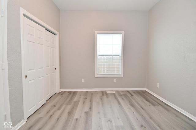 1709 Hoyt Ave, Indianapolis, IN 46203 - unfurnished bedroom with light wood-style floors and a closet