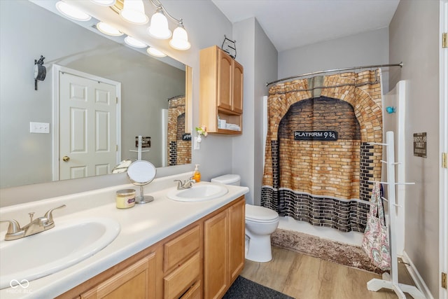 bathroom with toilet, curtained shower, hardwood / wood-style flooring, and vanity