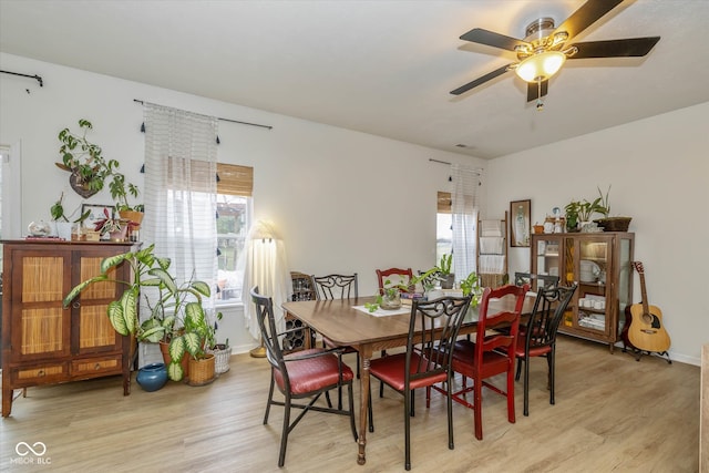 dining space with a wealth of natural light, light hardwood / wood-style flooring, and ceiling fan