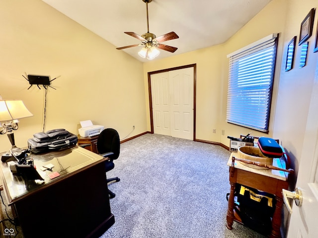 office space featuring carpet floors, ceiling fan, and vaulted ceiling