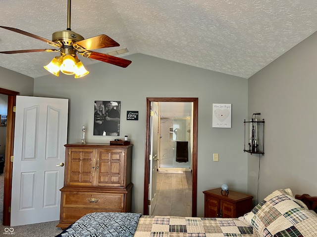 bedroom featuring ceiling fan, a textured ceiling, connected bathroom, vaulted ceiling, and light colored carpet