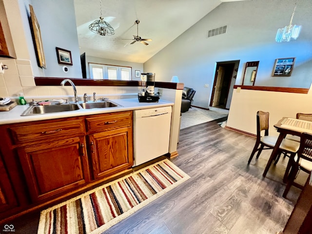 kitchen featuring sink, dishwasher, ceiling fan with notable chandelier, light hardwood / wood-style floors, and decorative light fixtures