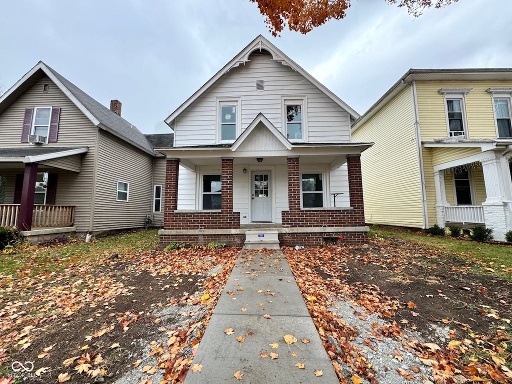 view of front of property with covered porch and cooling unit