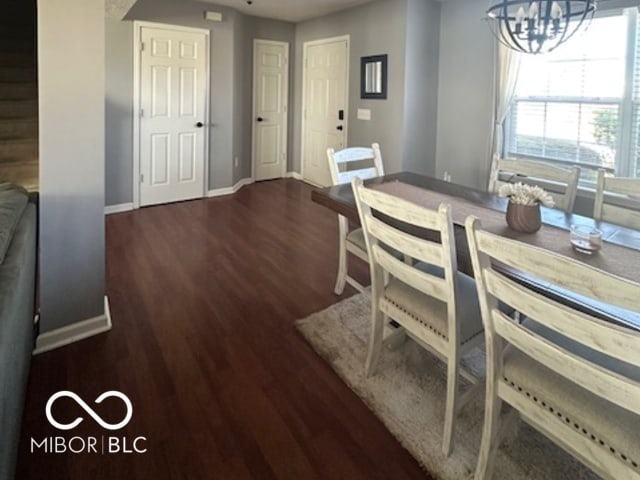 dining room featuring an inviting chandelier and dark hardwood / wood-style floors