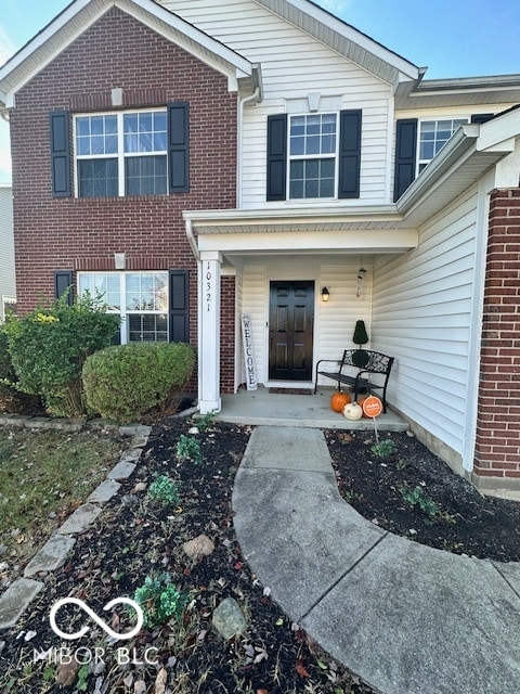 view of exterior entry with a porch