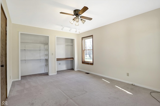 unfurnished bedroom with ceiling fan and light colored carpet