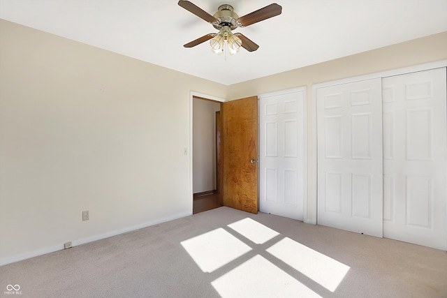 unfurnished bedroom with ceiling fan and light carpet