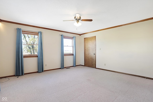 spare room featuring plenty of natural light, light carpet, and ceiling fan